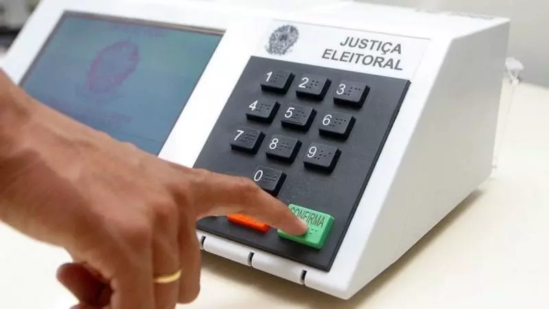 Pessoa preenchendo dados para votar em urna eletrônica 